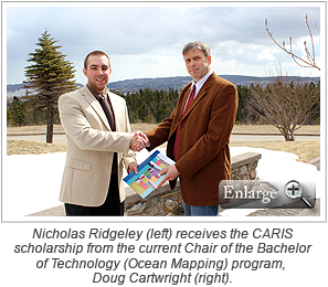 Nicholas Ridgeley (left) receives the CARIS scholarship from the current Chair of the Bachelor of Technology (Ocean Mapping) program, Doug Cartwright (right).