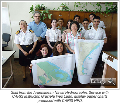 Staff from the Argentinean Naval Hydrographic Service with CARIS instructor, Graciela Inés Lado, display paper charts produced with CARIS HPD.